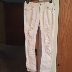 White distressed crop stretch jeans.